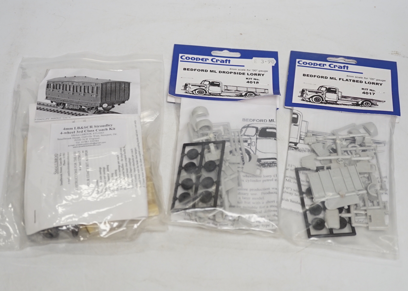 A collection of unmade, 4mm scale 00 gauge model, railway kits, and lineside accessories, including freight wagons, four-wheel coaches, commercial vehicles, etc. by Dapol, Cooper Craft, Parkside Dundas, etc. together wit